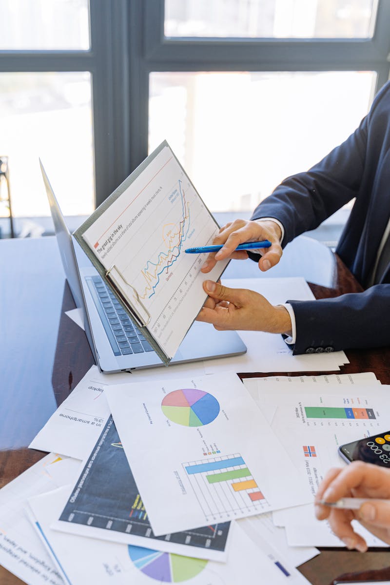 Person in Black Suit Jacket Holding White Paper - commercial lending solutions by fortify loans
