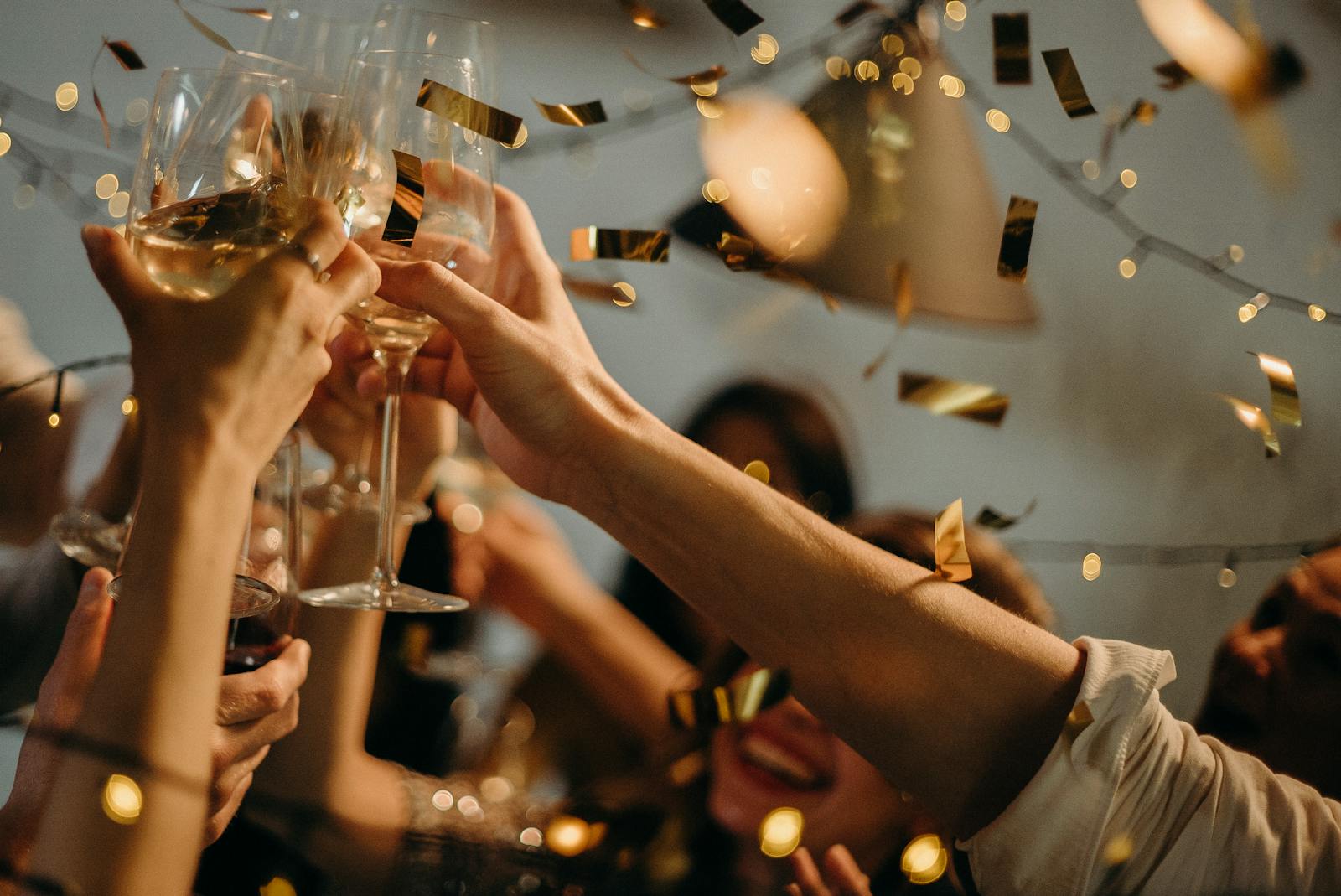 interest rate relief - A lively indoor party scene with people toasting champagne glasses amid confetti and warm lights.